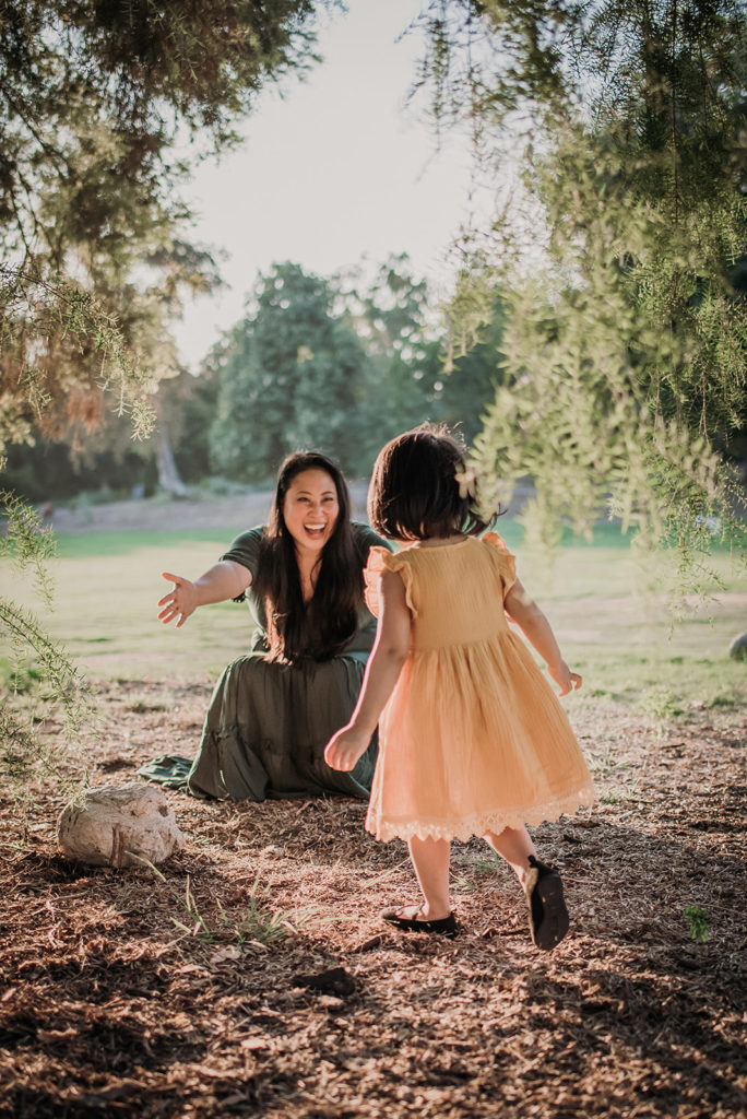 A mom hugs her daughter at the LA Arboretum